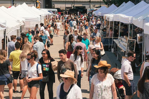 People walk around the SoWa open market and visit vendors' booths