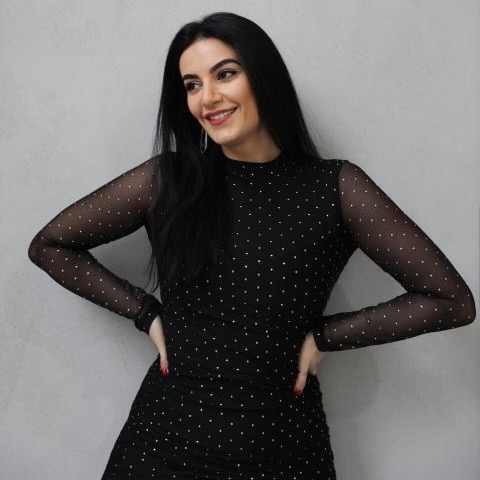 Lyusi Simon stands against a blank background