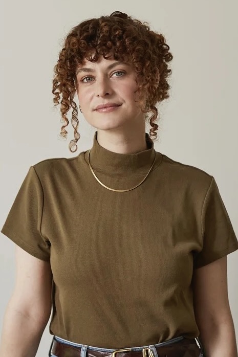 Portrait of Caitlin Bell with brown shirt