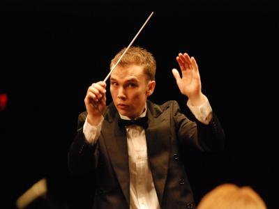 Young conductor performing in formal attire