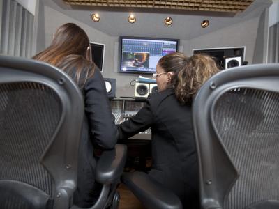 Two women at a digital music production workstation