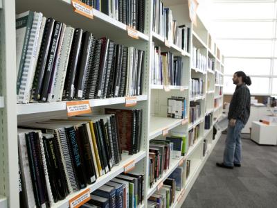 Person browsing shelves of music books