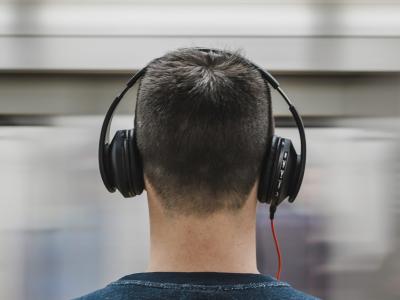Back of a man's head wearing headphones