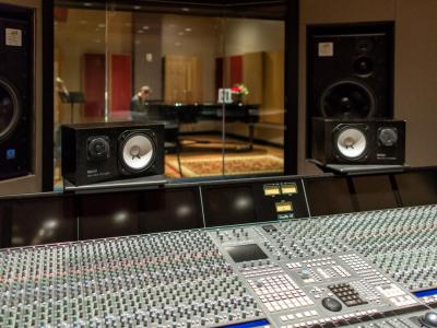 Recording studio and mixing console separated by a glass window