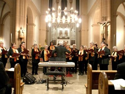 Church choir singing in front of an organ