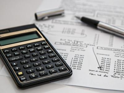 Calculator with document showing investment numbers