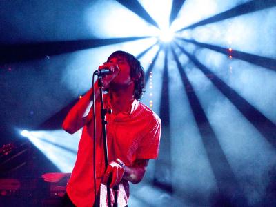 Musicians on stage with dramatic red and blue lighting effects