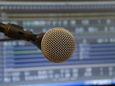 close up of microphone against electronic production software interface