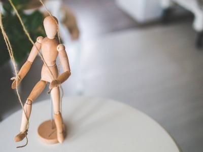 Wooden artist mannequin on strings