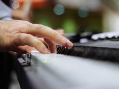 Man's hands on a piano