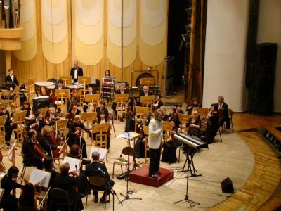 Orchestra seated on stage ready to perform