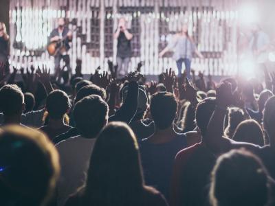 Large crowd in front of band performing on stage