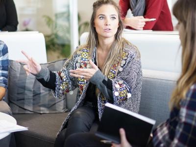 Young professionals having a discussion in a casual office space.