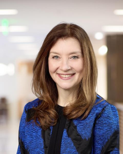 Portrait of a smiling Michele Darling wearing blue and black jacket.