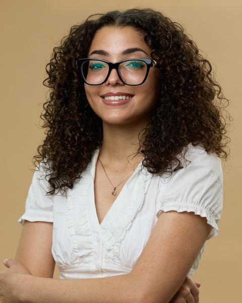 Ambar Perez poses in a white shirt with glasses