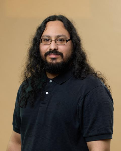 Miguel Diaz poses in a black polo 