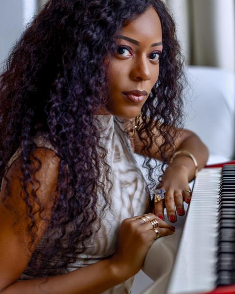 Briana Washington poses next to a keyboard