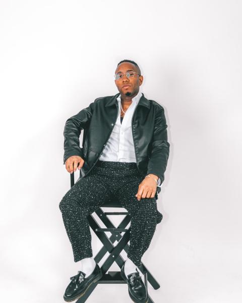 Tyson D. Jackson poses in a chair