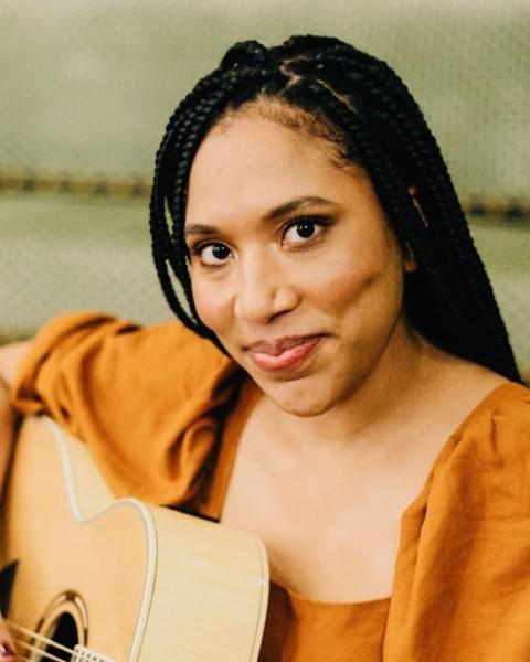 portrait of Jasmine Edwards playing guitar