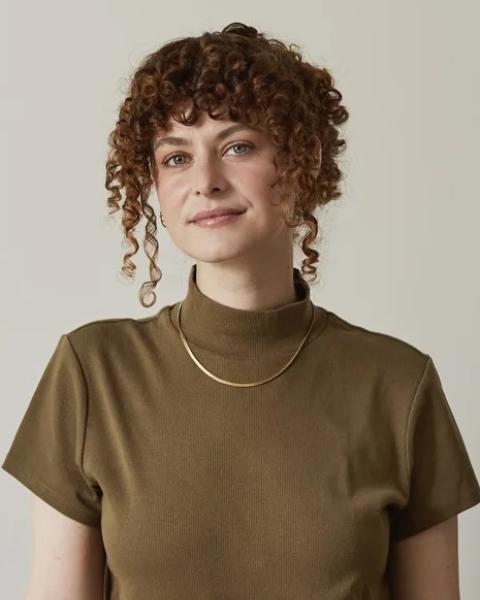 Portrait of Caitlin Bell with brown shirt