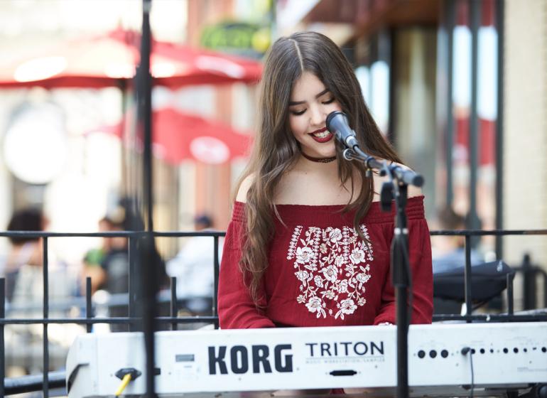 Student keyboardist performs outside 