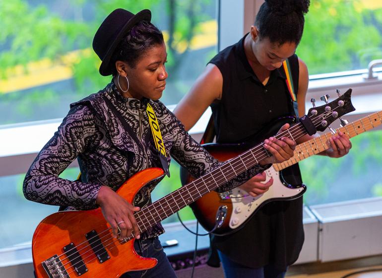 A student bassist and guitarist perform at Berklee 