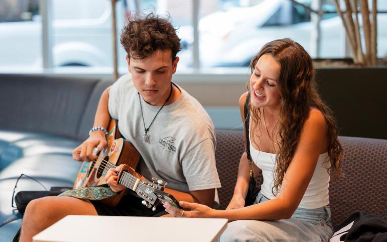 Two students work on a song together 