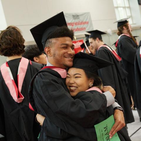 Students hugging at Commencement