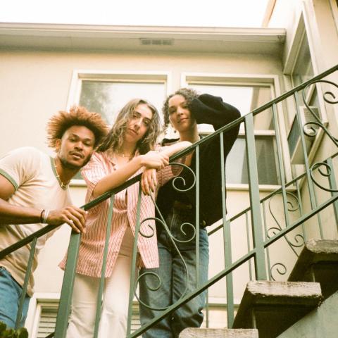 Judah, Maya, and Cinya standing on an outdoor stairway