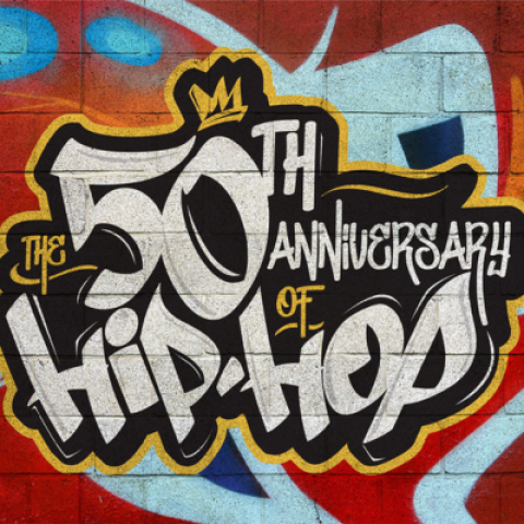 The words "50th Anniversary of Hip-Hop" painted in a graffiti style on a brick wall