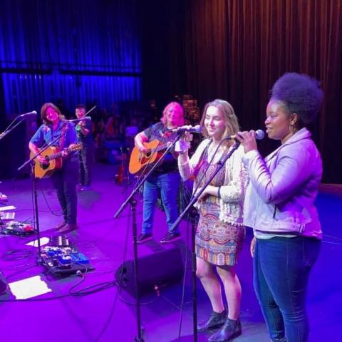 Photo of Berklee students performing with the Indigo Girls 