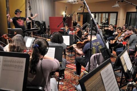 Students recording in a studio for a film scoring project