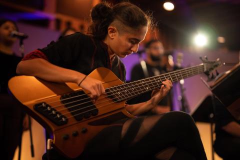 bassist seated, playing