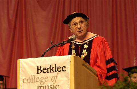 Portrait of Lee Berk in regalia standing at the podium