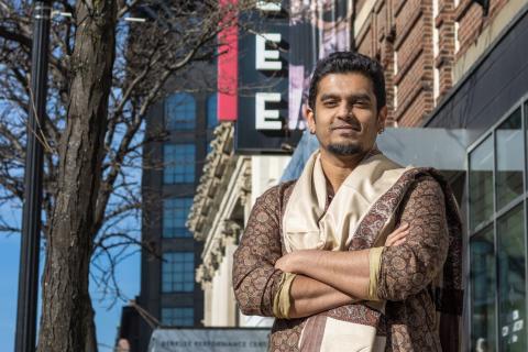 Shivaraj Natraj stands in front of Berklee sign