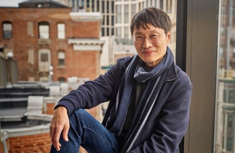 Boston Conservatory visiting artist Lei Liang smiling in front of a window