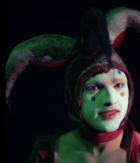 MKUltra dressed in a harlequin's hat and makeup.