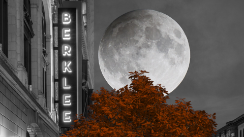 A black and white image of the Berklee marquee sign with a full moon in the background and a red tree in the foreground