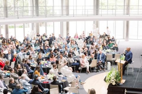 Hundreds of brunch guests listen to keynote speaker at past event.