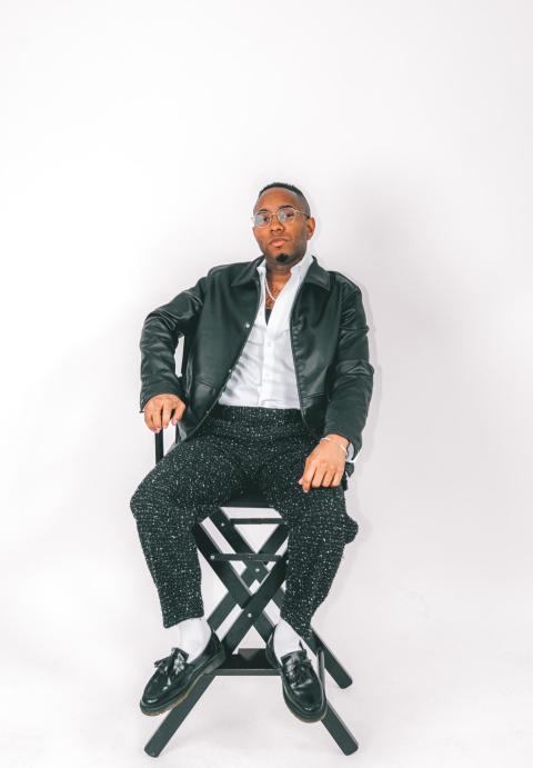 Tyson D. Jackson poses in a chair
