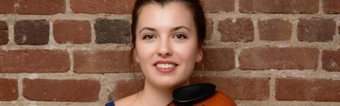 Lucy Khadder poses against a brick background