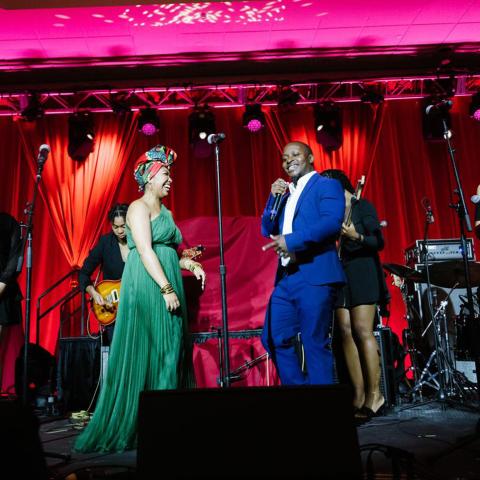 student in green dress at gala on stage