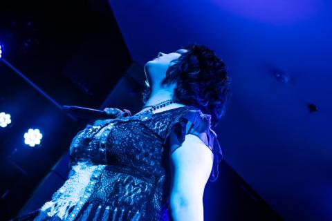 Juno Meyers is caught in a wash of blue light during the masterclass, another intentional motion shot.