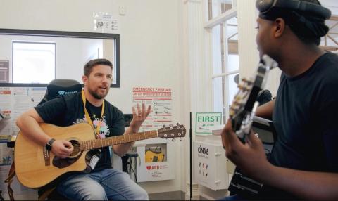 Rick Aggeler works with a student at the Mattapan Teen Center