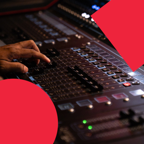 An LMPD student adjusts a console fader.