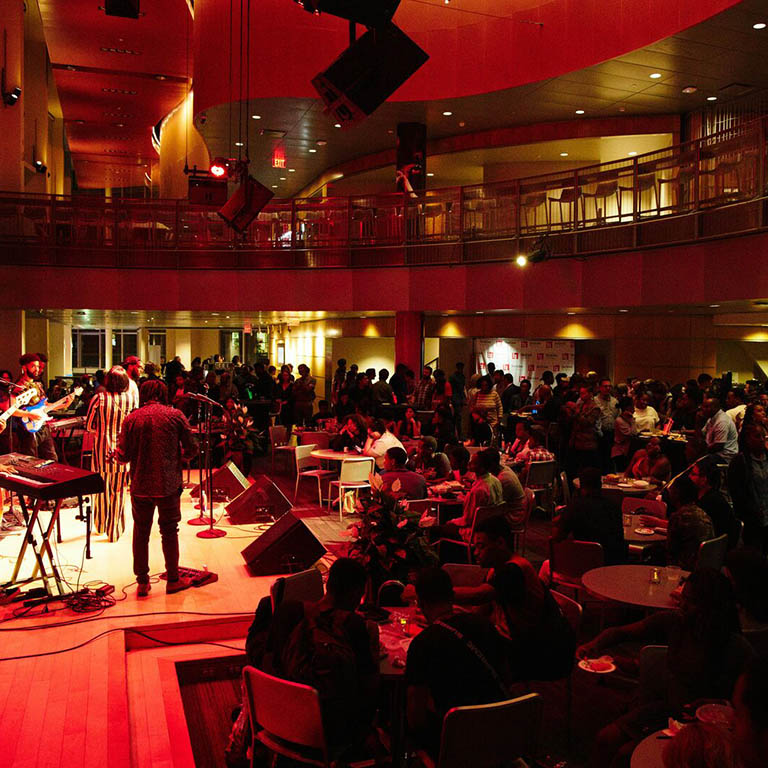 A performance on the Jackson Browne Stage at a crowded Berklee Dining Hall